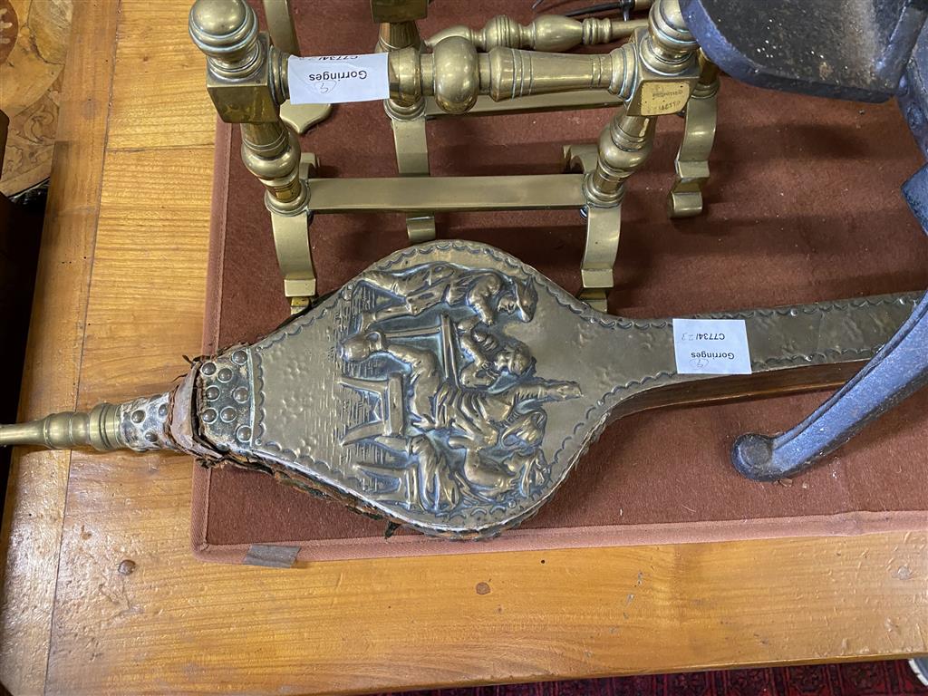 A late Victorian brass framed mirrored firescreen, a pair of brass fire dogs, a pair of bellows, set of bellows ,four brass fire implem